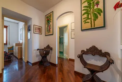 a living room with two chairs and a hallway at GuestHost - Flaminio Apartment panoramic view with terrace in Rome