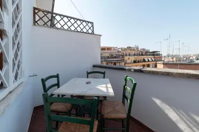 a table and chairs on a balcony with a view at GuestHost - Flaminio Apartment panoramic view with terrace in Rome