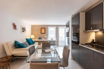a kitchen and living room with a couch and a table at Lovely Cozy Apartment Parioli in Rome