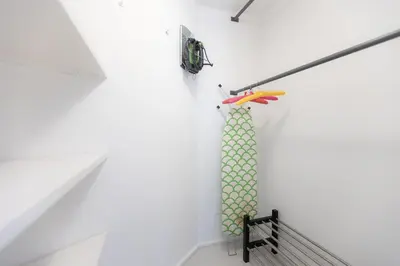 a room with a white wall with a green shower curtain at Lovely Cozy Apartment Parioli in Rome