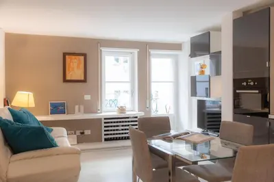 a living room with a glass table and chairs at Lovely Cozy Apartment Parioli in Rome