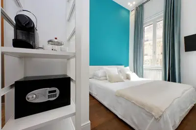 a small bedroom with a bed and a window at Fontana di Trevi dream home in Rome