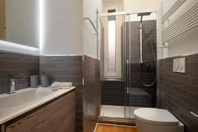 a bathroom with a shower and a toilet and a sink at St.Peter's1928 in Rome