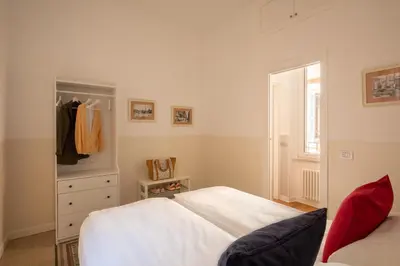 a bedroom with a bed and a dresser and a window at St.Peter's1928 in Rome