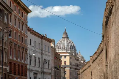 a view of a city street with a domed building at St.Peter's1928 in Rome