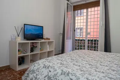 a bedroom with a bed and a tv and a window at La casetta ai colli - Vicino alla Metro A in Rome