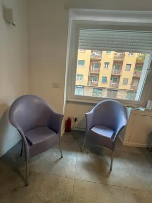 two chairs sitting in a room with a window at Claudio Vaticano Home in Rome