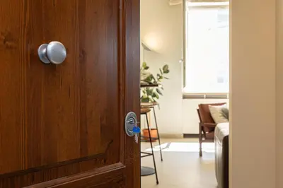a wooden door with a knob on it in a living room at Lovely Cozy Nazionale 4 in Rome