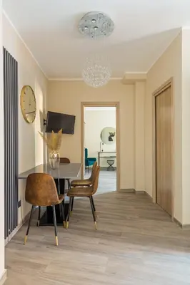 a dining room with a table and chairs and a clock at Charming Trastevere Two in Rome