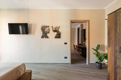 a bedroom with a bed and a dining room at Charming Trastevere Two in Rome