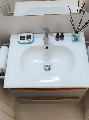 a white sink in a bathroom with a scale on it at Barberini Bright Apartment in Rome