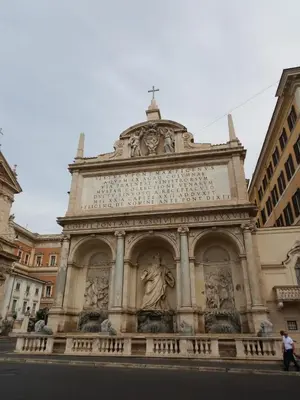 a building with a statue on top of it at Barberini Bright Apartment in Rome