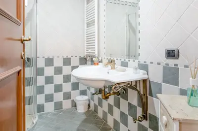 a bathroom with a sink and a mirror at Vinylogy Apartment 5to Piano in Rome