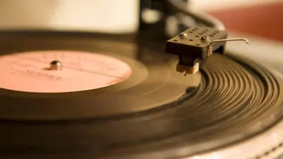a close up of a vinyl record on a record player at Vinylogy Apartment 5to Piano in Rome