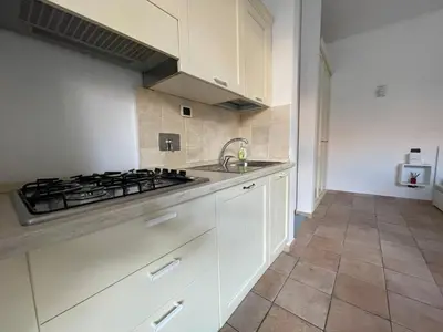 a kitchen with white cabinets and a stove at Gens Julia in Rome