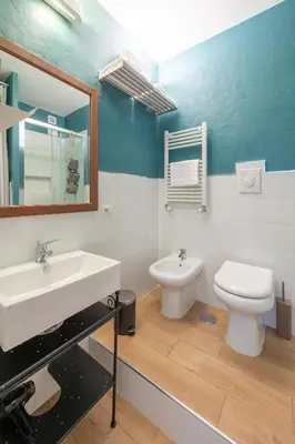 a bathroom with a sink and a toilet at SuityRHome San Pietro 99 in Rome