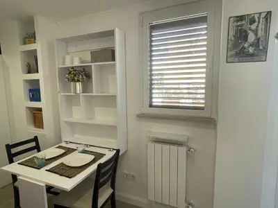 a small kitchen with a table and a window at Little Aventino BnB in Rome