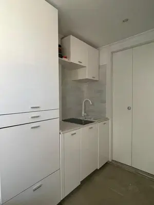a white kitchen with white cabinets and a sink at Little Aventino BnB in Rome
