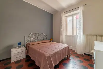 a bedroom with a bed and a window at GuestHost - San Lorenzo Welcoming Apartment in Rome