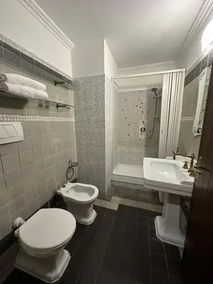 a bathroom with a toilet and a sink and a tub at Alloggio Turistico in Rome