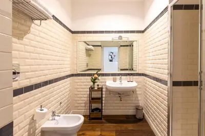 a bathroom with two sinks and a mirror at Alla Corte Guest House by Hili in Rome