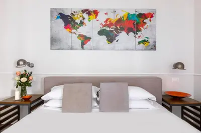 a bedroom with a bed and a world map on the wall at Alla Corte Guest House by Hili in Rome