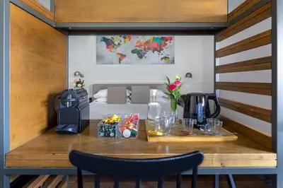 a room with a table with a coffee maker and a bed at Alla Corte Guest House by Hili in Rome