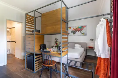 a room with a bunk bed and a desk with a chair at Alla Corte Guest House by Hili in Rome
