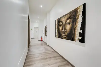 a hallway with two large artworks on the walls at Relais Colonna in Rome