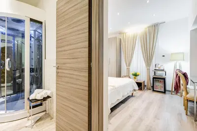 a bedroom with a bed and a sliding glass door at Relais Colonna in Rome