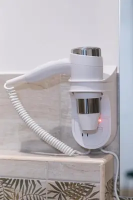 a white phone sitting on top of a wooden stand at Domus Vatican Holiday in Rome