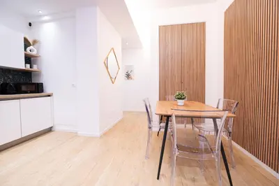 a dining room with a wooden table and chairs at Domus Vatican Holiday in Rome