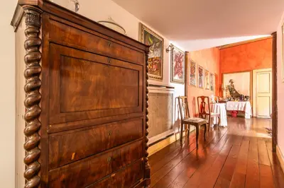 a large wooden door in a room with a dining room at Suite Palazzo Bonaventura in Rome