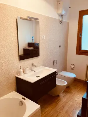 a bathroom with a sink and a toilet and a mirror at Domus Cornelia in Rome