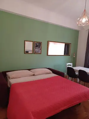 a bedroom with a large bed with a red blanket at Domus Cornelia in Rome