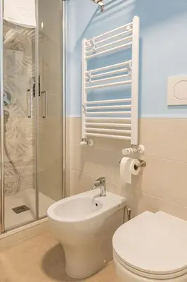 a bathroom with a shower and a toilet and a sink at Domus76 Casa Vacanze in Rome