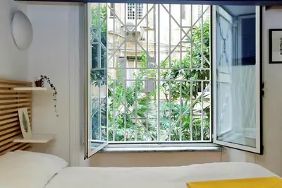 a bedroom with a window with a view of a building at Vatican Holiday Home in Rome