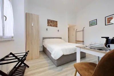 a bedroom with a bed and a table in it at suity I cozy barberini studio in Rome