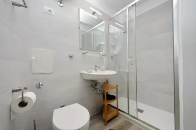 a bathroom with a toilet and a sink and a shower at suity I cozy barberini studio in Rome