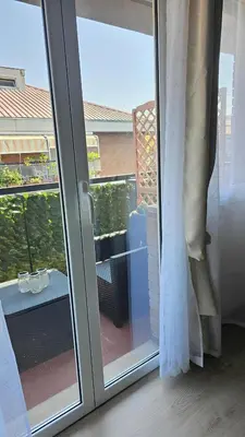 a sliding glass door with a view of a balcony at Convenient Booking B&B in Rome