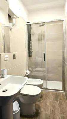 a bathroom with a toilet sink and a shower at Convenient Booking B&B in Rome