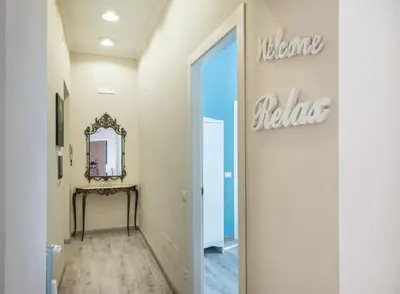 a hallway with a welcome sign on the wall at Roma Design Rooms San Giovanni Colosseo Area in Rome