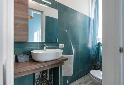 a bathroom with a sink and a toilet and a mirror at Roma Design Rooms San Giovanni Colosseo Area in Rome