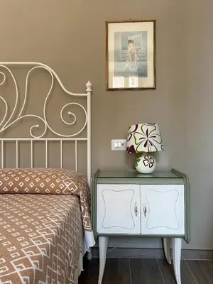 a bedroom with a bed and a nightstand and a picture at Casa Minerva a Testaccio in Rome
