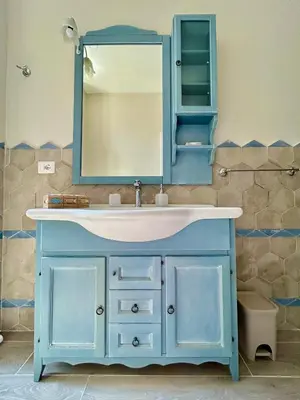 a bathroom with a blue sink and a mirror at Casa Minerva a Testaccio in Rome
