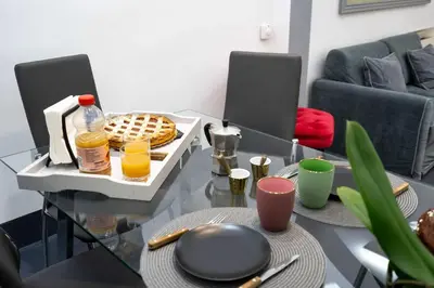 a living room with a glass table with food on it at White Style Gambero in Rome
