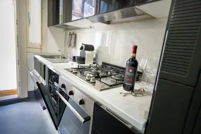 a bottle of wine sitting on top of a stove in a kitchen at White Style Gambero in Rome