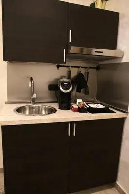 a kitchen counter with a sink and a microwave at Jadore Monic in Rome