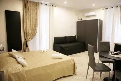 a bedroom with a bed and a chair and a couch at Jadore Monic in Rome