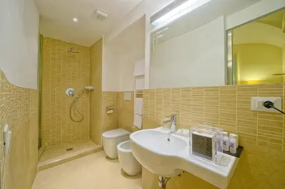 a bathroom with a sink and a toilet and a shower at Star Vatican Rooms in Rome